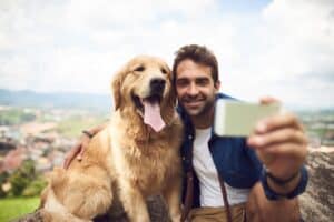 Man and his dog taking a selfie while hiking