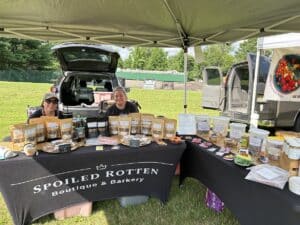 Gourmet dog treat vendor booth at a farmer's market